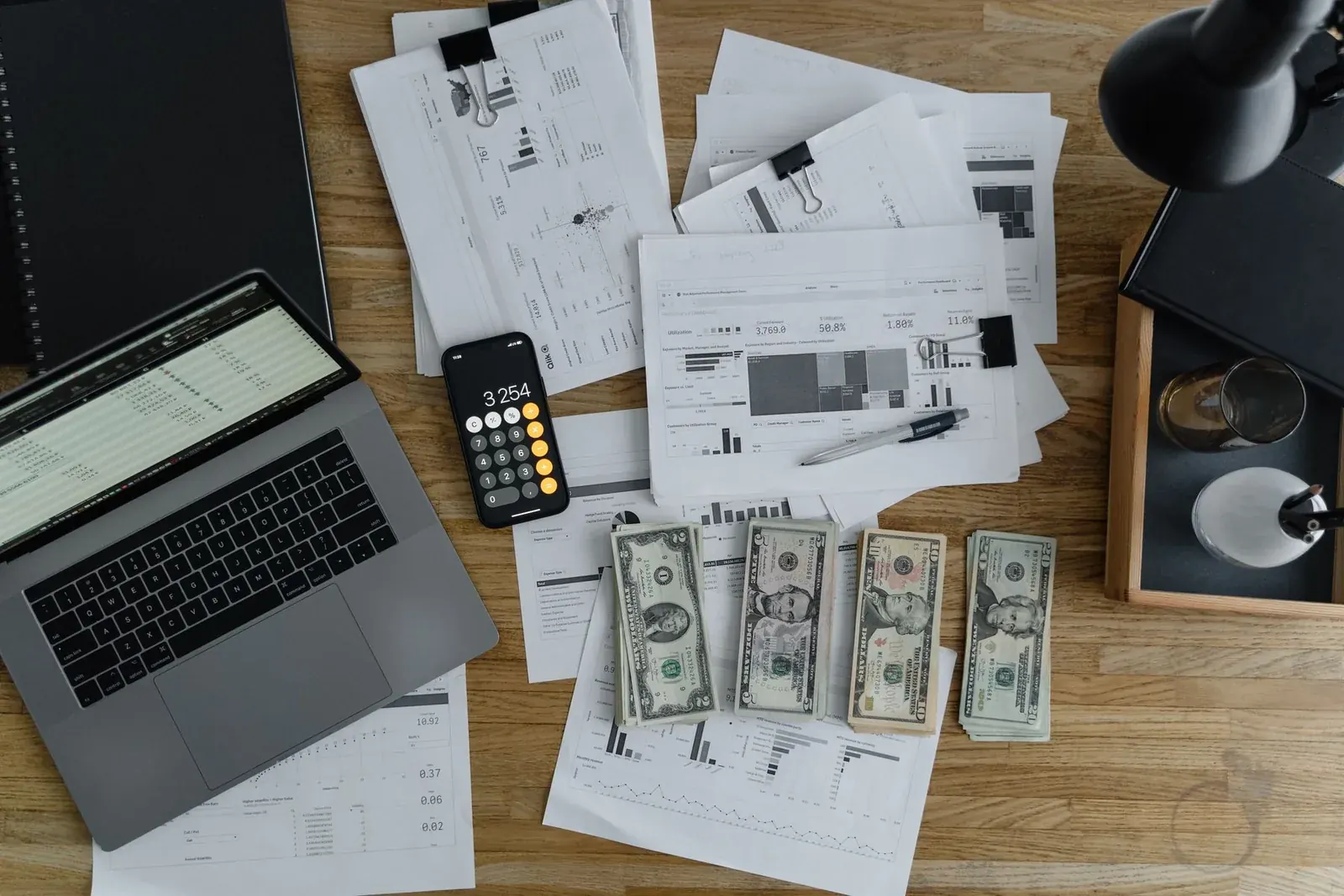 Laptop, calculator and reports used to forecast a company’s cash flow